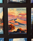 a collection of magnets with various scenic landscapes, including mountains, forests, and bodies of water. The magnets are arranged in a grid-like pattern, with each one depicting a different natural setting. The magnets are predominantly blue and green in color, creating a harmonious and visually appealing composition.