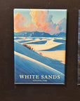 A framed magnet depicting a scenic landscape with mountains, clouds, and a body of water, with the text "WHITE SAND" and "NATIONAL PARK" printed on it.