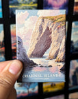 A hand holding a magnet with a picture of a rocky cliff and water in the background, with the text "Channel Islands National Park" visible.