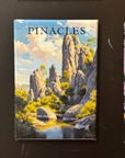 The image is a framed magnet depicting a scenic landscape with a river, mountains, and trees.