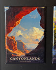 The image is a framed magnet depicting a scenic landscape with mountains, clouds, and a river.