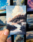 A hand holding a magnet with a landscape scene depicting a tree and a body of water, with the text "BISCAYNE NATIONAL PARK" visible.