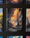 a collection of landscape magnets, each depicting a different natural scene. The magnets are arranged in a grid-like pattern, showcasing various pictures of national parks and natural attractions. The magnets feature a variety of colors and styles, creating a visually appealing display.