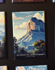 a collection of magnets depicting various scenic landscapes, including mountains, forests, and other natural features.