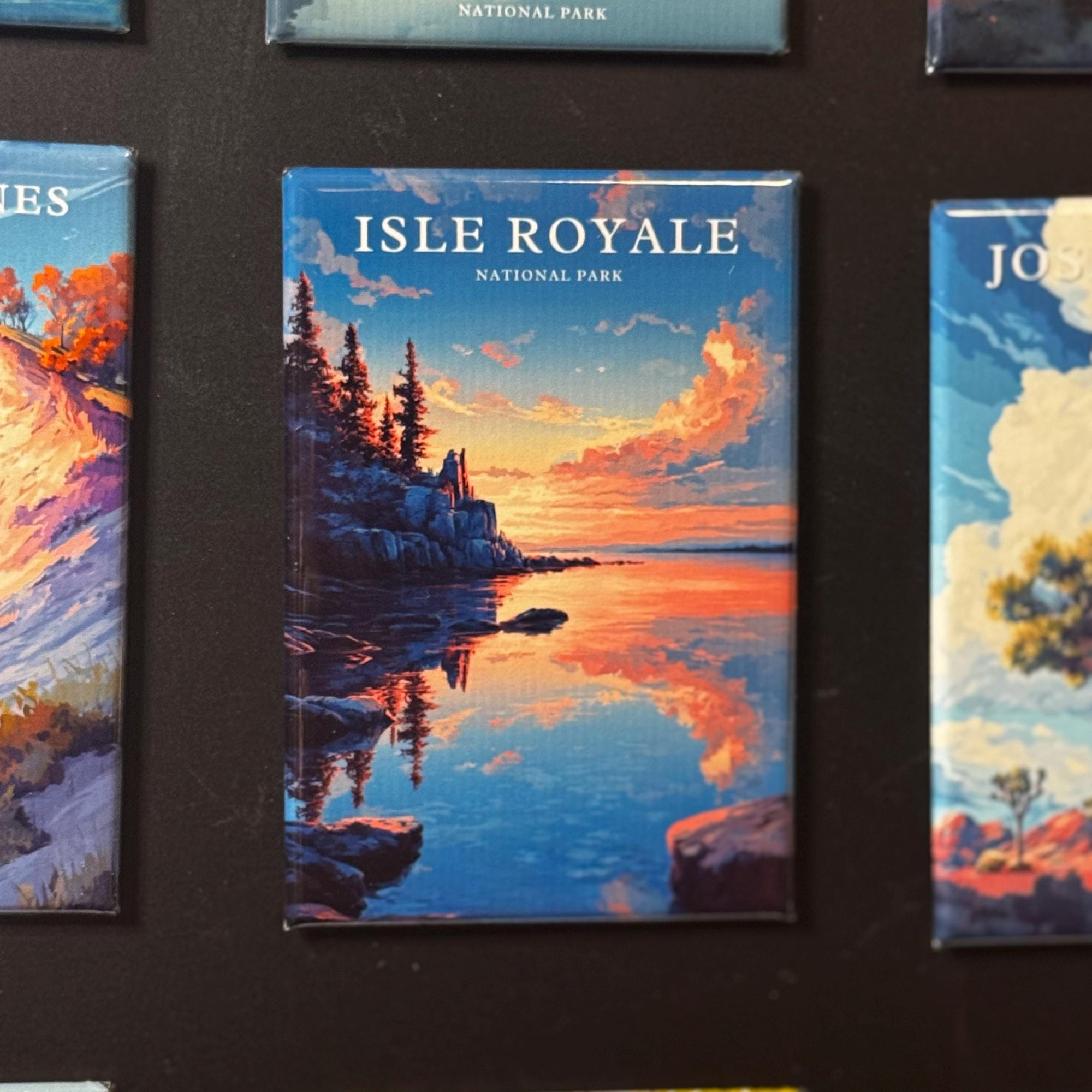 a collection of landscape magnets, including one depicting the Isle Royale National Park in the United States.