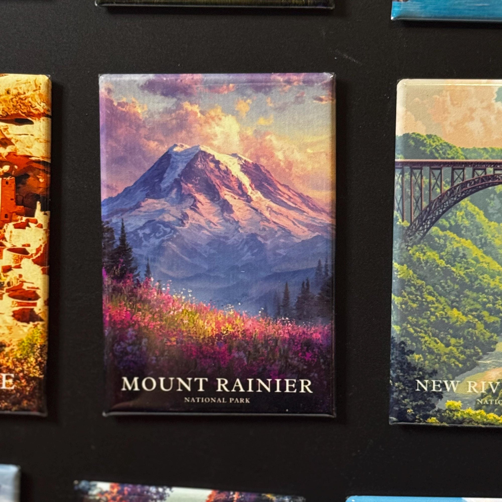 a collage of various landscape scenes, including a mountain, a bridge, and a field of flowers. The text "Mount Rainier" and "National Park" are visible, indicating that these are landscape scenes from a National Park.