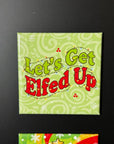 A square magnet with the text "Let's Get Elfed Up" on it, which appears to be a humorous Christmas-themed phrase.