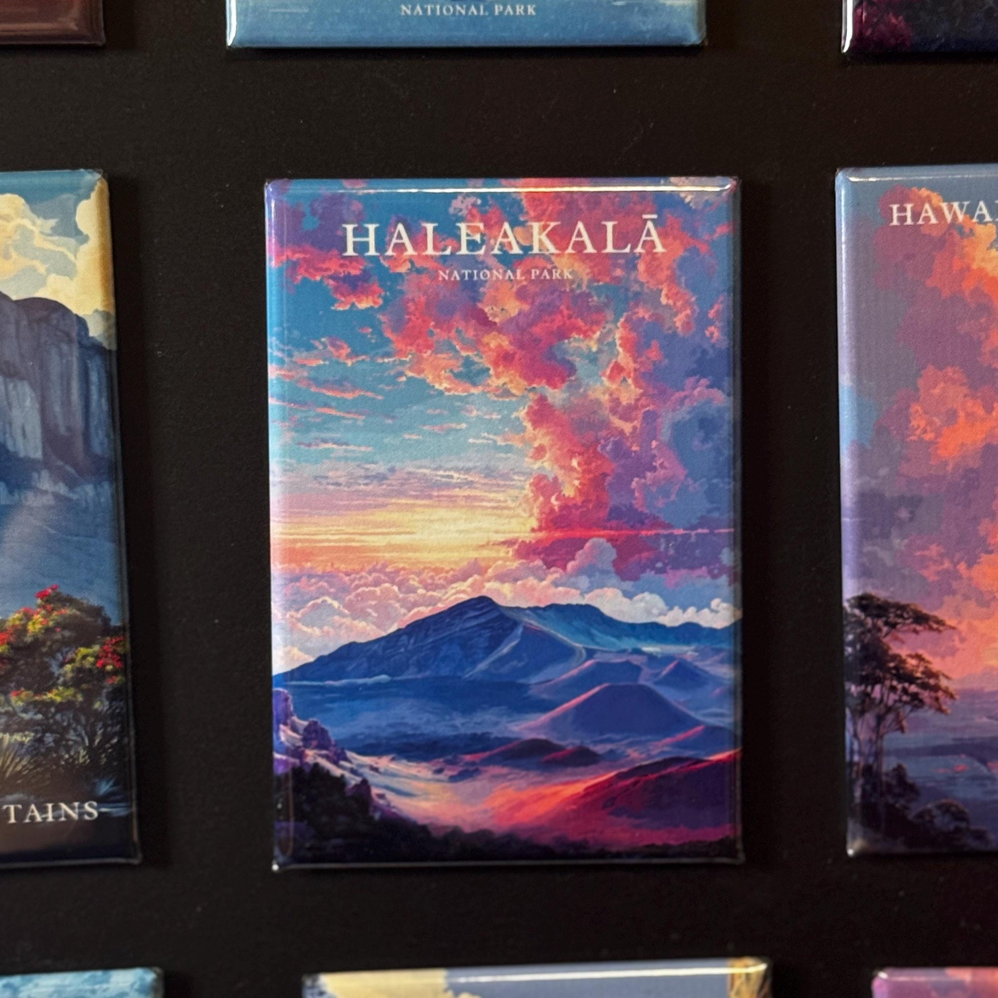 a collection of colorful magnets depicting various landscapes, including mountains, clouds, and natural scenery.