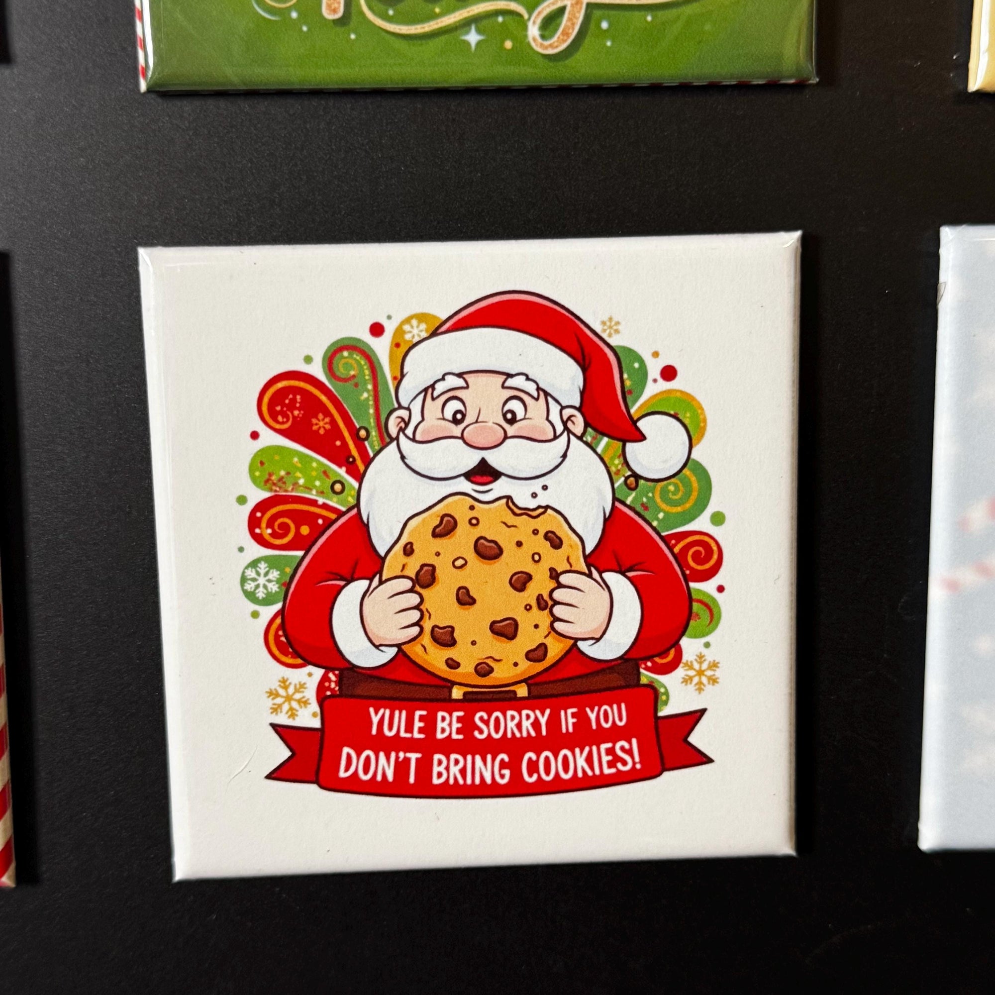 Santa Claus holding a cookie and wearing a Santa hat, with a banner that says &amp;quot;YULE BE SORRY IF YOU DON&amp;