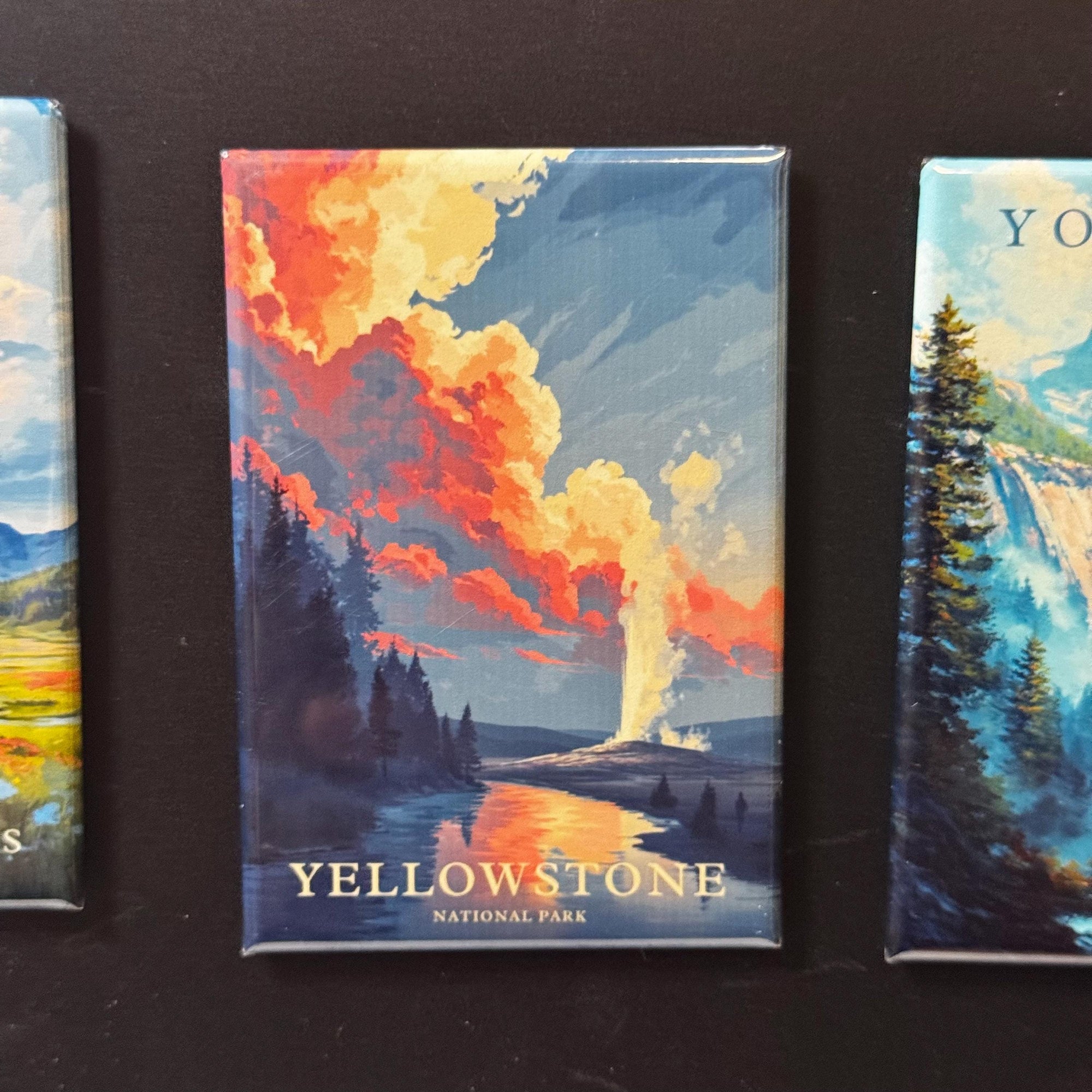 a collection of landscape magnets, including a magnet depicting a scenic view of Yellowstone National Park.