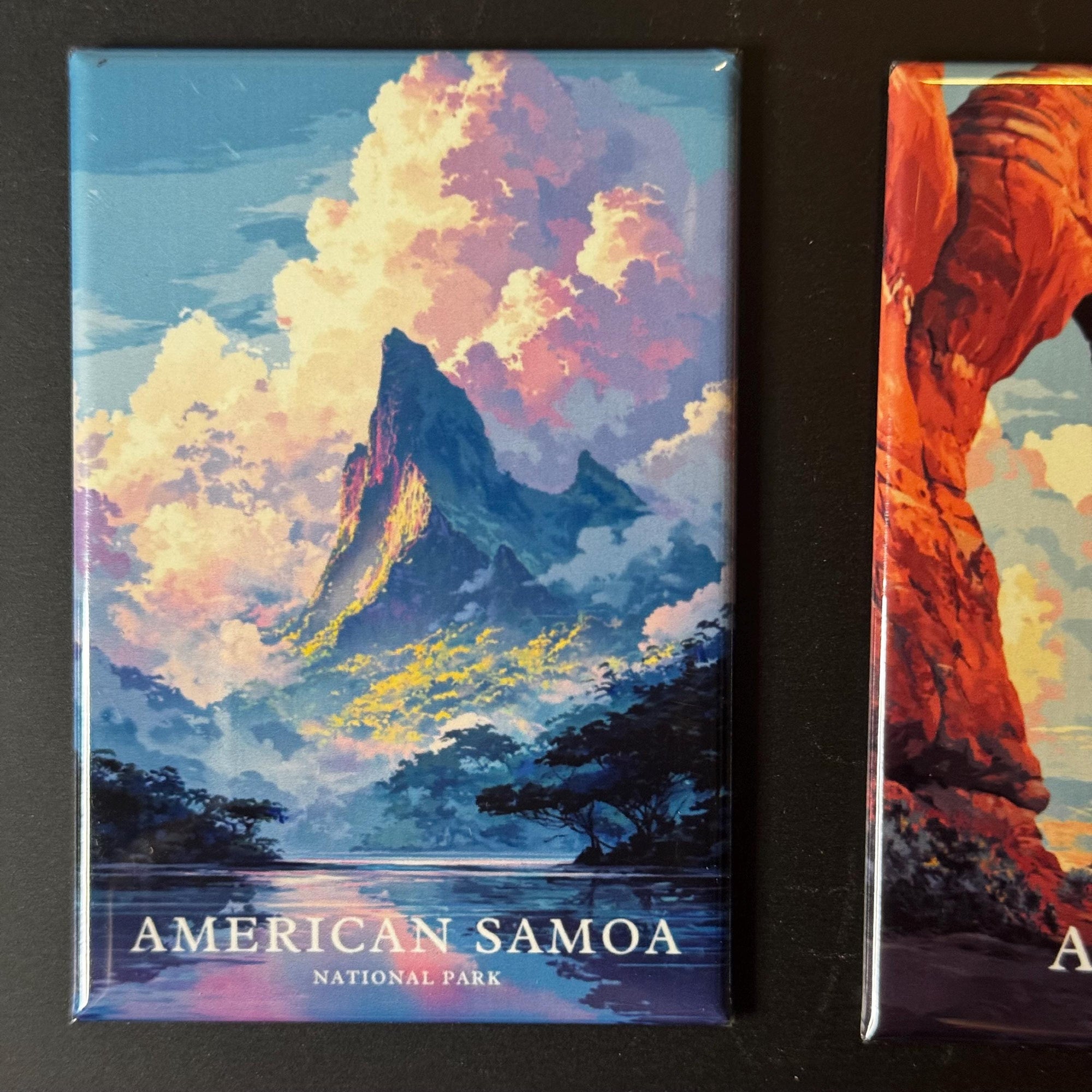 a landscape with mountains, clouds, and a body of water, with the text "AMERICAN SAMOA NATIONAL PARK" prominently displayed.