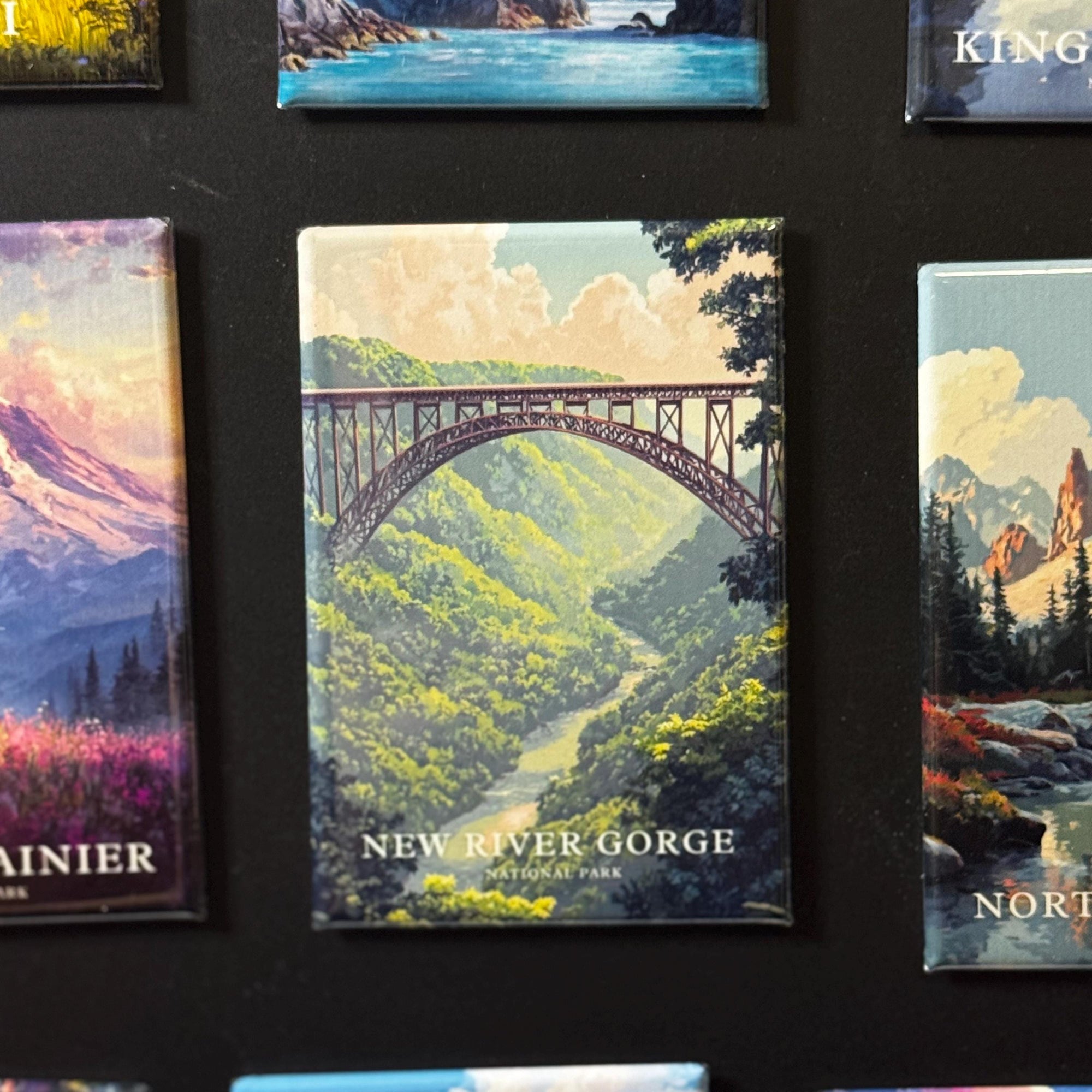 a collage of various landscape scenes, including a bridge over a river, mountains, and forests.